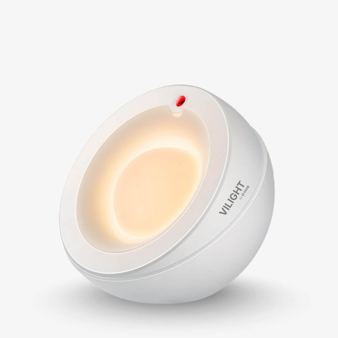 Product photography of a VILIGHT by O Rons white spherical lamp with a warm yellow glow emanating from its inner concave design and a small red indicator light